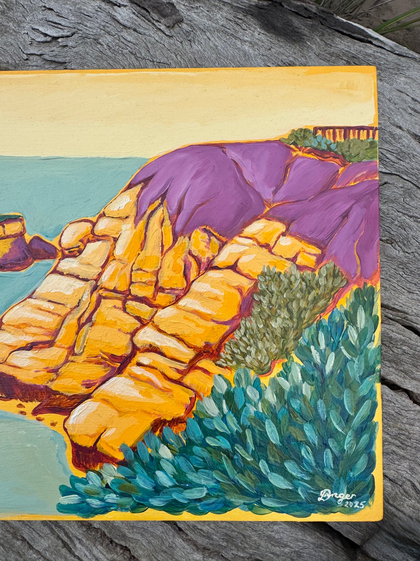 Detail image of Torquay Rocky Point in Yellow artwork on board. Sitting on a log in a bush setting. Artwork inspired by Surf Coast, Great Ocean Road, Victoria, Australia.