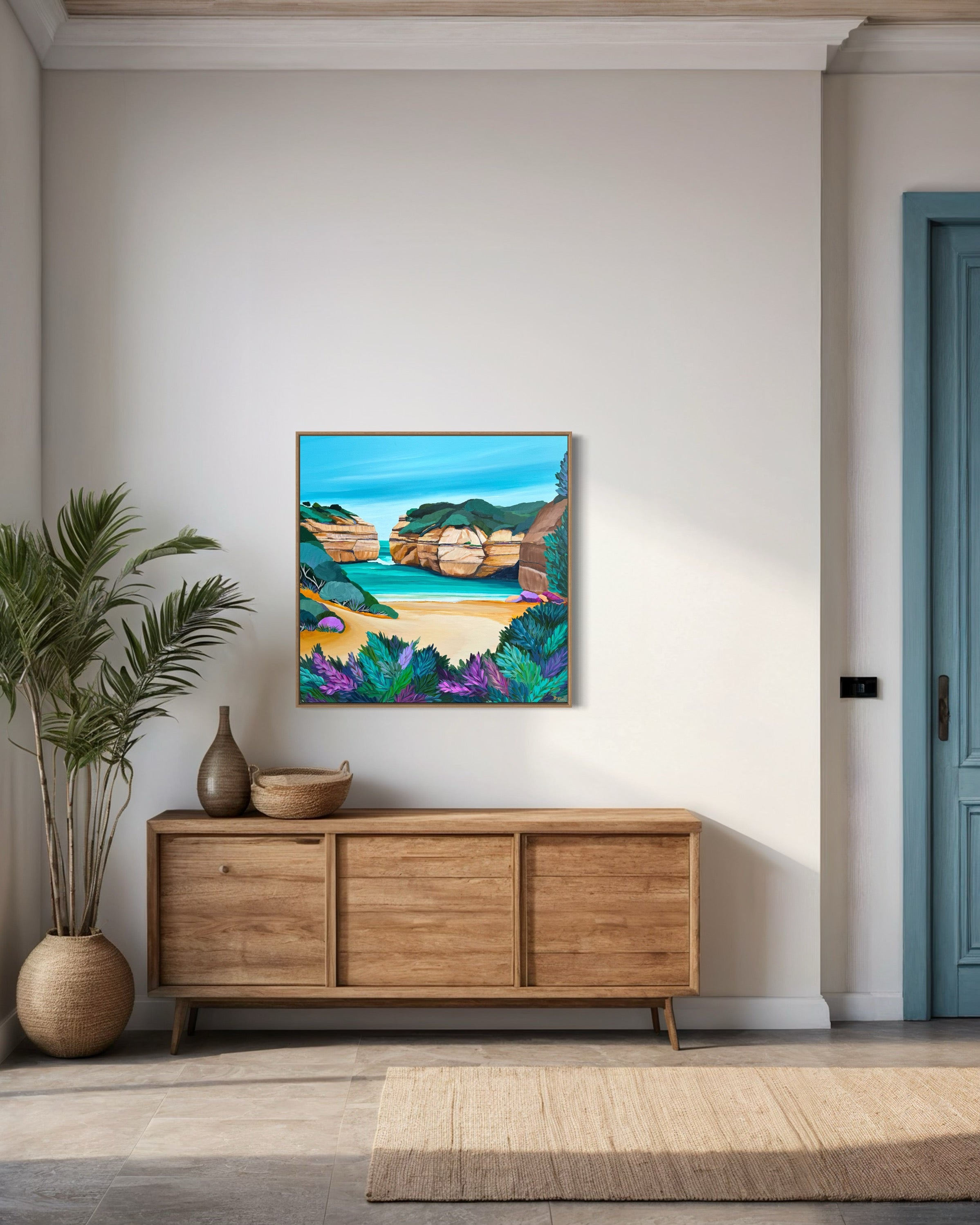 Framed painting on a wall above a wooden cabinet with a plant and rug in a room.