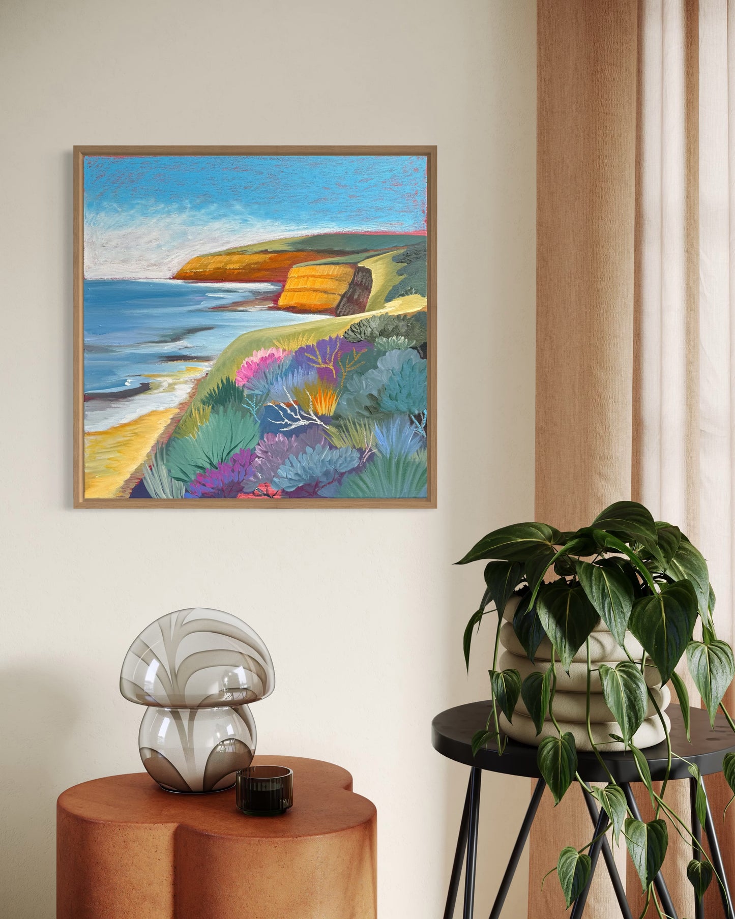 Jan Juc at Day living room, a colourful seascape original painting on living room wall behind an indoor plant. Painting inspired by the Surf Coast location of Jan Juc near Torquay, Victoria, Australia.