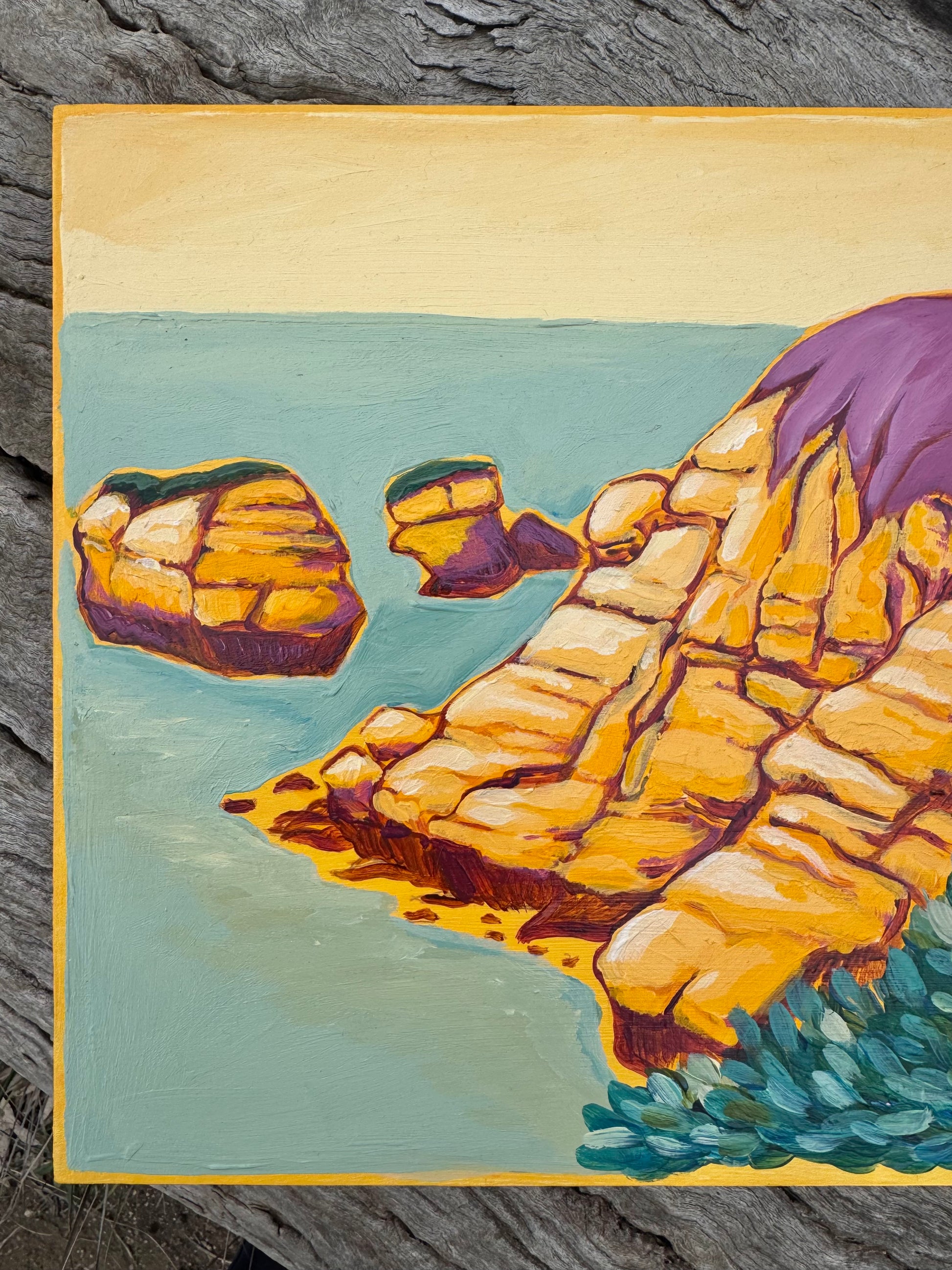 Detail image of Torquay Rocky Point in Yellow artwork on board.  Sitting on a log in a bush setting.  Artwork inspired by Surf Coast, Great Ocean Road, Victoria, Australia.