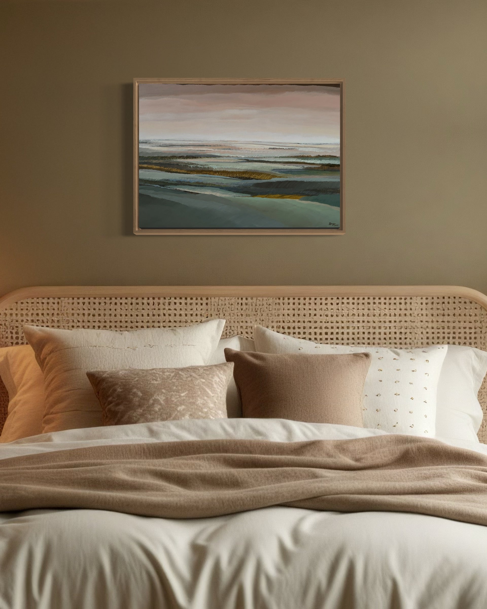 Bedroom with a bed featuring pillows and a blanket, and a painting on the wall.