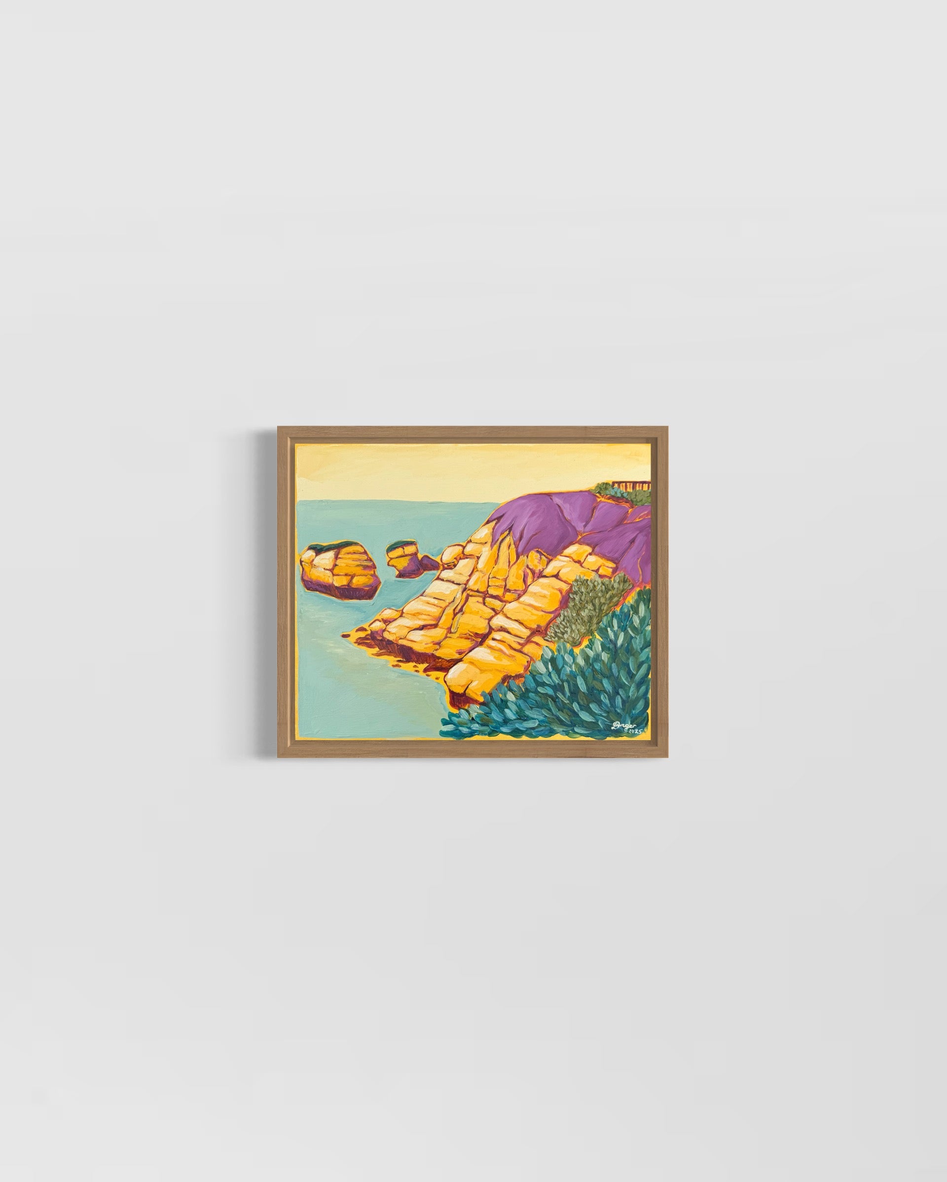 Torquay - Rocky Point in Yellow artwork framed in raw oak, mixed media on board created by artist Lauren Danger.  Artwork displayed on a white wall.