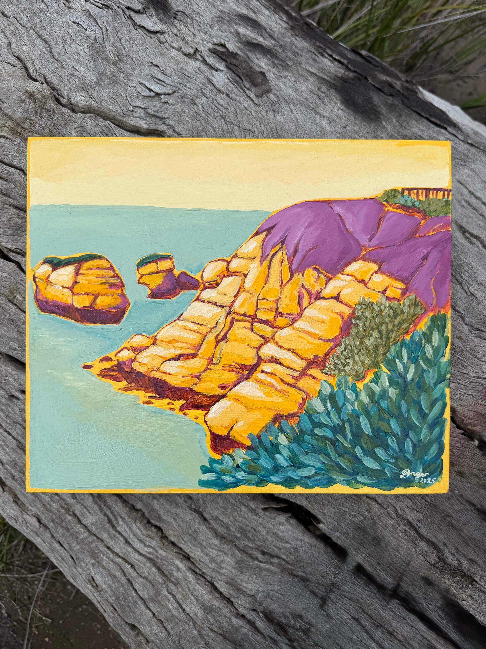 Torquay Rocky Point in Yellow artwork on board.  Sitting on a log in a bush setting.  Artwork inspired by Surf Coast, Great Ocean Road, Victoria, Australia.